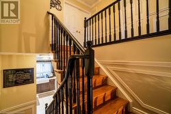 Stairs featuring sink, tile patterned flooring, and ornamental molding - 