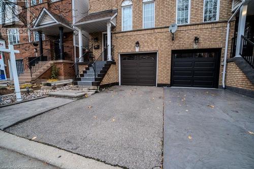 View of front of property with a garage - 1480 Britannia Road W Unit# 143, Mississauga, ON - Outdoor With Facade