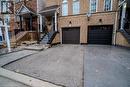 View of front of property with a garage - 1480 Britannia Road W Unit# 143, Mississauga, ON  - Outdoor With Facade 