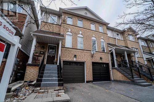 View of property featuring a garage - 1480 Britannia Road W Unit# 143, Mississauga, ON - Outdoor With Facade