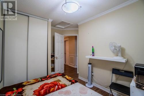 Bedroom featuring crown molding, dark hardwood / wood-style flooring, and a textured ceiling - 1480 Britannia Road W Unit# 143, Mississauga, ON - Indoor Photo Showing Bedroom