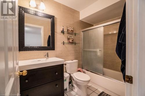 Full bathroom with vanity, combined bath / shower with glass door, tile patterned flooring, toilet, and tile walls - 1480 Britannia Road W Unit# 143, Mississauga, ON - Indoor Photo Showing Bathroom