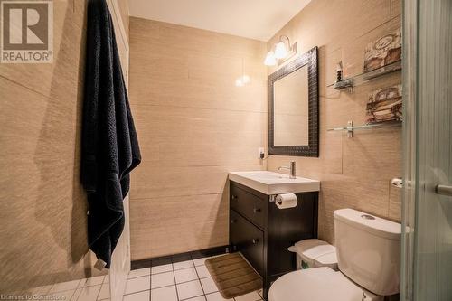 Bathroom featuring tile patterned floors, vanity, tile walls, and toilet - 1480 Britannia Road W Unit# 143, Mississauga, ON - Indoor Photo Showing Bathroom