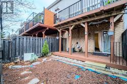 Rear view of house featuring a deck and central AC unit - 