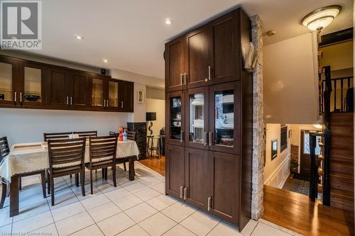 Kitchen featuring dark brown cabinets and light wood-type flooring - 1480 Britannia Road W Unit# 143, Mississauga, ON - Indoor