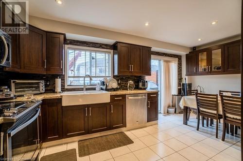 Kitchen with backsplash, a healthy amount of sunlight, sink, and stainless steel appliances - 1480 Britannia Road W Unit# 143, Mississauga, ON - Indoor Photo Showing Kitchen