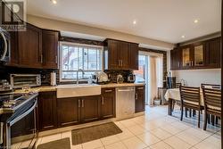 Kitchen with backsplash, a healthy amount of sunlight, sink, and stainless steel appliances - 