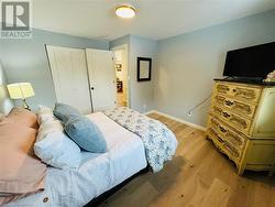 Bedroom featuring light hardwood / wood-style floors and a closet - 