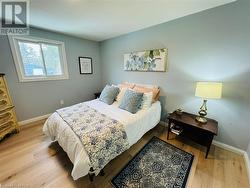 Bedroom with light hardwood / wood-style flooring - 