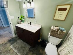 Bathroom with hardwood / wood-style floors, vanity, and toilet - 