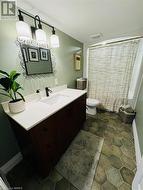 Bathroom with vanity and toilet - 