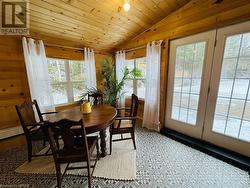 Dining room with wooden walls, wooden ceiling, and lofted ceiling - 