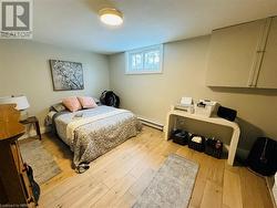 Bedroom featuring light hardwood / wood-style floors and baseboard heating - 