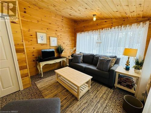 Living room with wood walls, lofted ceiling, and wooden ceiling - 541 Donald Street, Mattawa, ON - Indoor Photo Showing Living Room