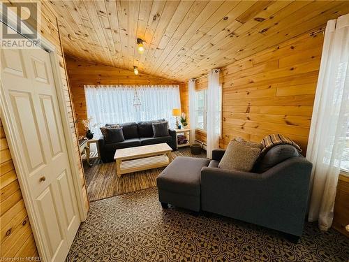 Living room featuring wood walls, wood ceiling, and vaulted ceiling - 541 Donald Street, Mattawa, ON - Indoor Photo Showing Living Room