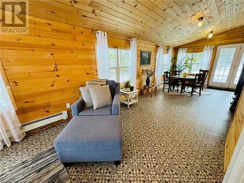 Sitting room with a baseboard heating unit, wooden walls, lofted ceiling, and wood ceiling - 541 Donald Street, Mattawa, ON -  With Exterior