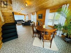 Dining room with vaulted ceiling, wood walls, and wood ceiling - 