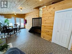 Bedroom with vaulted ceiling, wooden walls, and wood ceiling - 