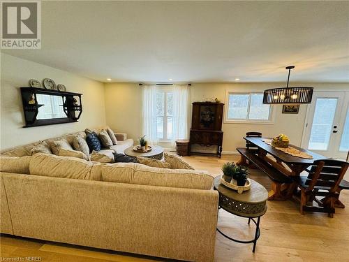 Living room featuring a healthy amount of sunlight, light wood-type flooring, and a chandelier - 541 Donald Street, Mattawa, ON - Indoor Photo Showing Living Room