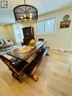 Dining space with light hardwood / wood-style flooring and a healthy amount of sunlight - 