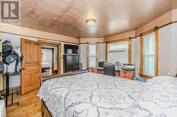 Bedroom with light wood-type flooring and multiple windows - 