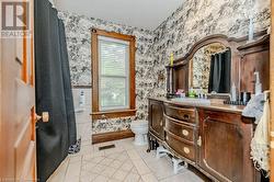 Bathroom with tile patterned floors, vanity, and toilet - 