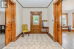 Entrance foyer featuring crown molding and light hardwood / wood-style flooring - 