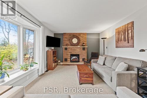 7897 Beaverdams Road, Niagara Falls, ON - Indoor Photo Showing Living Room With Fireplace