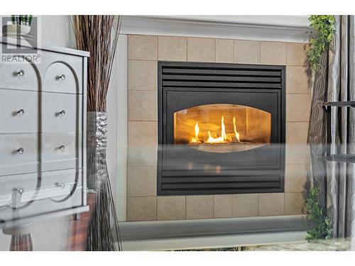 Natural Gas fireplace. - 683 Victoria Street Unit# 308, Kamloops, BC - Indoor Photo Showing Living Room With Fireplace