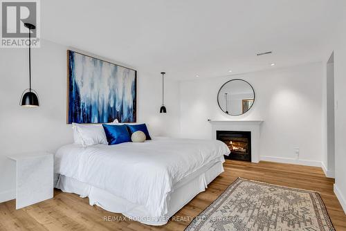 7494 Bamsey Drive, Hamilton Township, ON - Indoor Photo Showing Bedroom With Fireplace