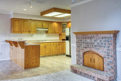 4587 Postill Drive, Kelowna, BC - Indoor Photo Showing Kitchen With Fireplace