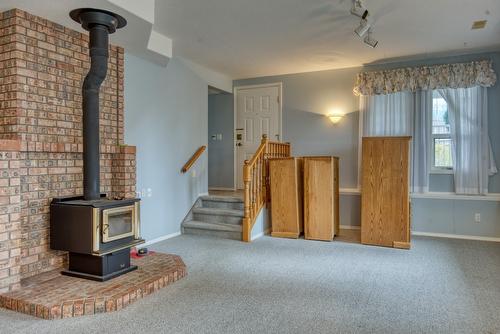 4587 Postill Drive, Kelowna, BC - Indoor Photo Showing Other Room With Fireplace