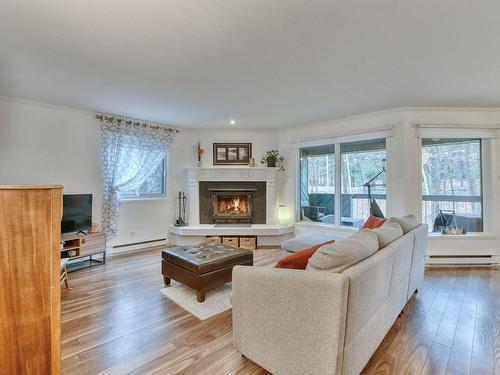 Living room - D-700 Ch. Des Trois-Villages, Piedmont, QC - Indoor Photo Showing Living Room With Fireplace