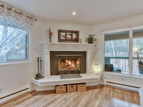 Living room - D-700 Ch. Des Trois-Villages, Piedmont, QC - Indoor Photo Showing Living Room With Fireplace