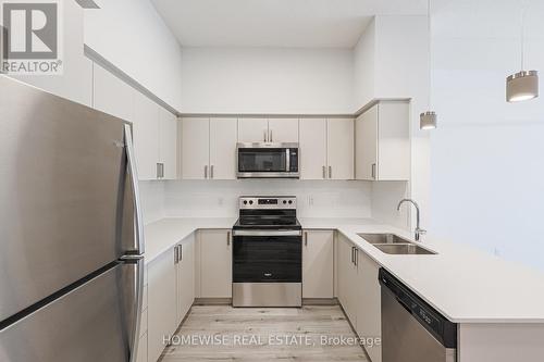 210 - 1475 Whites Road, Pickering, ON - Indoor Photo Showing Kitchen With Stainless Steel Kitchen With Double Sink