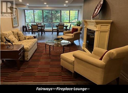 202 - 1400 Dixie Road, Mississauga, ON - Indoor Photo Showing Living Room With Fireplace