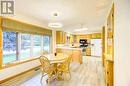 Kitchen with kitchen peninsula, tasteful backsplash, white refrigerator with ice dispenser, stainless steel gas stove, and light hardwood / wood-style floors - 3 Maitland Street, Blandford, ON  - Indoor 