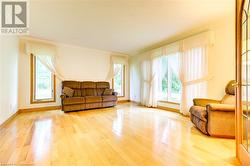 Sitting room featuring hardwood / wood-style floors and ornamental molding - 