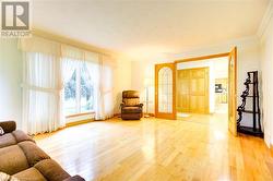 Sitting room featuring light hardwood / wood-style floors and ornamental molding - 