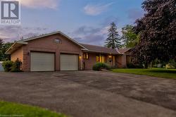 Single story home with a garage and a lawn - 