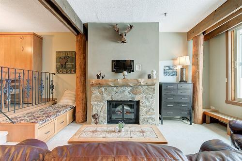 402-7470 Porcupine Road, Big White, BC - Indoor Photo Showing Living Room With Fireplace