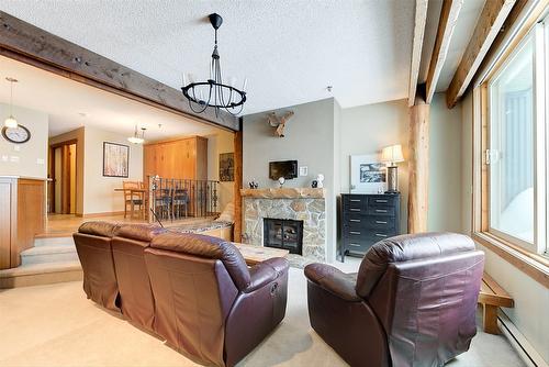 402-7470 Porcupine Road, Big White, BC - Indoor Photo Showing Living Room With Fireplace