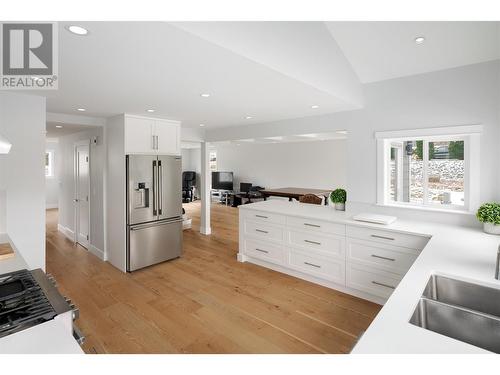 New custom kitchen with quartz & Westwood cabintery - 3960 June Springs Road, Kelowna, BC - Indoor Photo Showing Kitchen