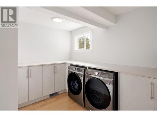 Large laundry room with ample storage and counterspace - 3960 June Springs Road, Kelowna, BC - Indoor Photo Showing Laundry Room