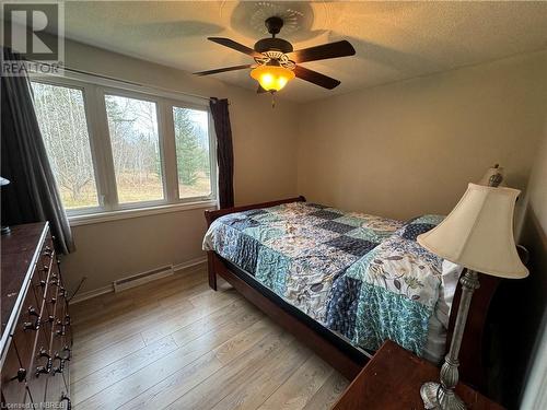 Bedroom featuring ceiling fan, light hardwood / wood-style flooring, and a textured ceiling - 3877 Highway 17 E, Mattawa, ON - Indoor Photo Showing Bedroom