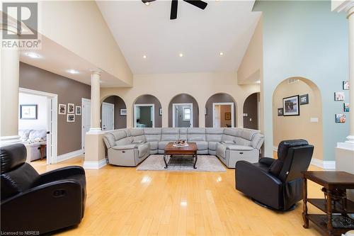 Living room with light hardwood / wood-style floors, high vaulted ceiling, and decorative columns - 748 Coursol Road, Sturgeon Falls, ON - Indoor Photo Showing Living Room