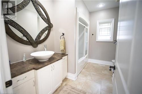 Bathroom featuring tile patterned flooring, vanity, and combined bath / shower with glass door - 748 Coursol Road, Sturgeon Falls, ON - Indoor Photo Showing Bathroom