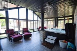 Sunroom / solarium featuring a jacuzzi and a wealth of natural light - 