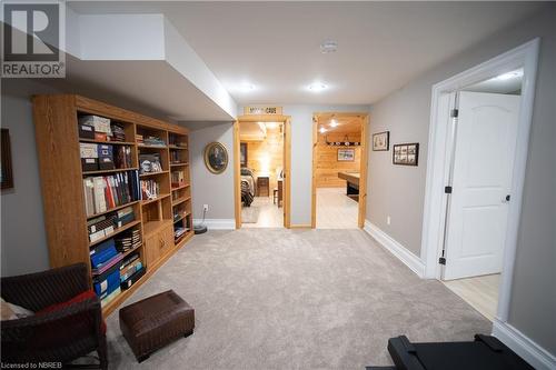 Living area featuring wood walls and light carpet - 748 Coursol Road, Sturgeon Falls, ON - Indoor Photo Showing Other Room