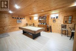 Rec room with wooden ceiling, wooden walls, light hardwood / wood-style floors, and billiards - 